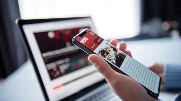 News cover image featuring the news on a laptop and mobile phone