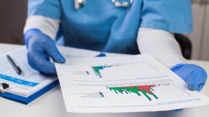Image of a health professional looking at a chart